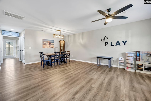 dining room featuring visible vents, baseboards, and wood finished floors