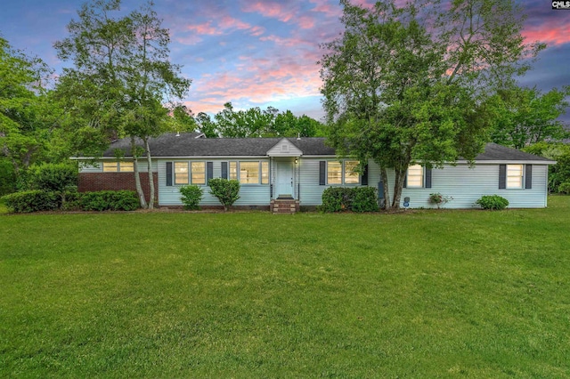 ranch-style home featuring a front yard