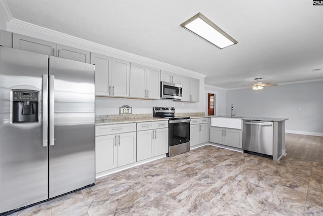kitchen featuring ornamental molding, a peninsula, a sink, appliances with stainless steel finishes, and gray cabinetry