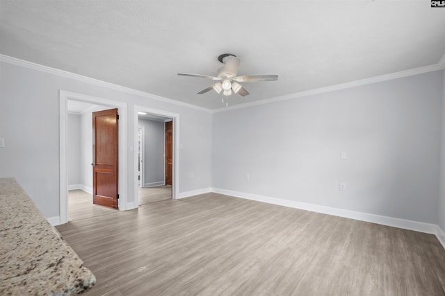 unfurnished living room featuring baseboards, ceiling fan, ornamental molding, and light wood-style flooring