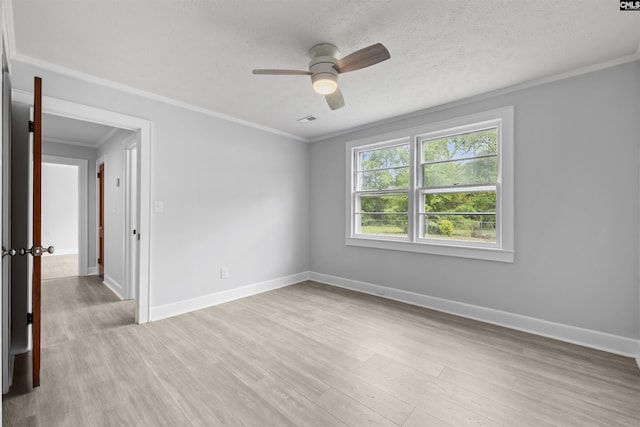 unfurnished room featuring light wood-type flooring, a ceiling fan, baseboards, and ornamental molding