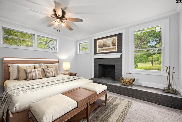 bedroom with carpet, ornamental molding, a fireplace, and ceiling fan