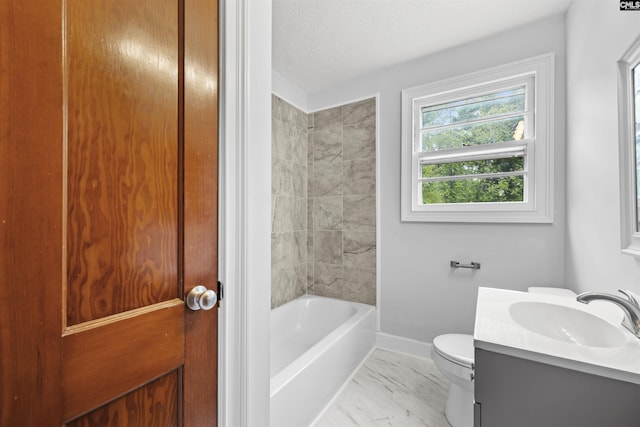 bathroom featuring vanity, marble finish floor, toilet, baseboards, and a textured ceiling