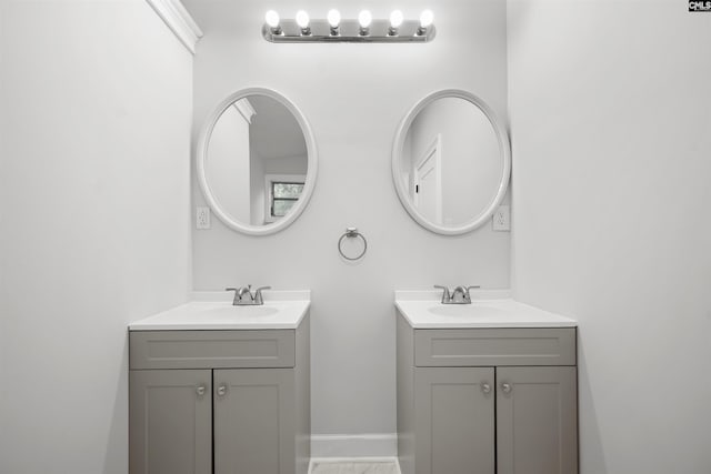 bathroom with two vanities and a sink