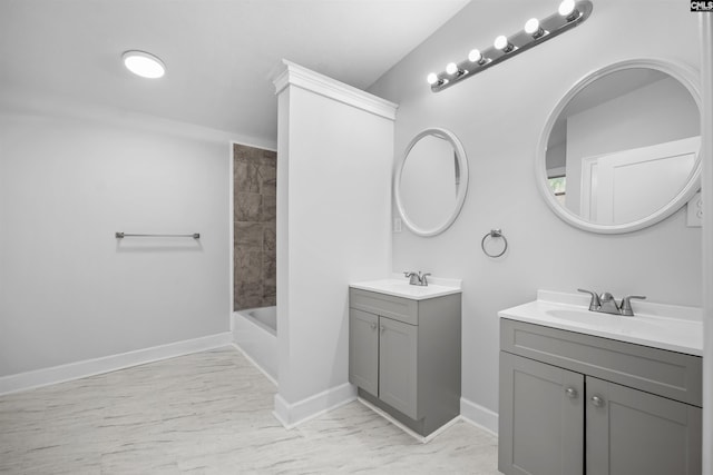 bathroom with baseboards, two vanities, and a sink