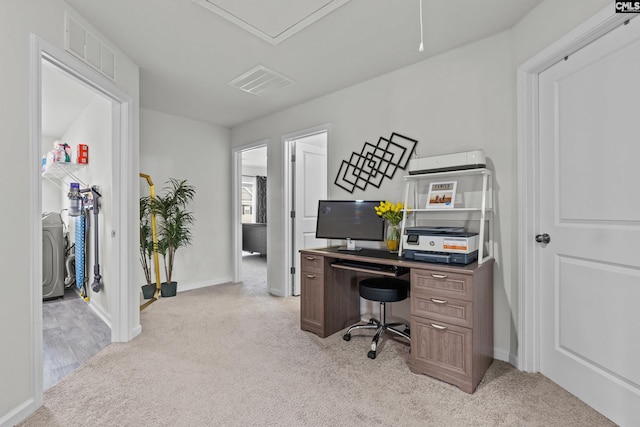 home office featuring baseboards, visible vents, and light carpet