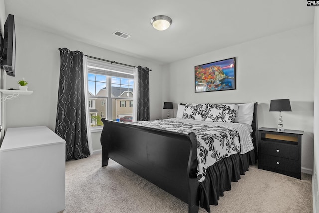 bedroom featuring light colored carpet, baseboards, and visible vents
