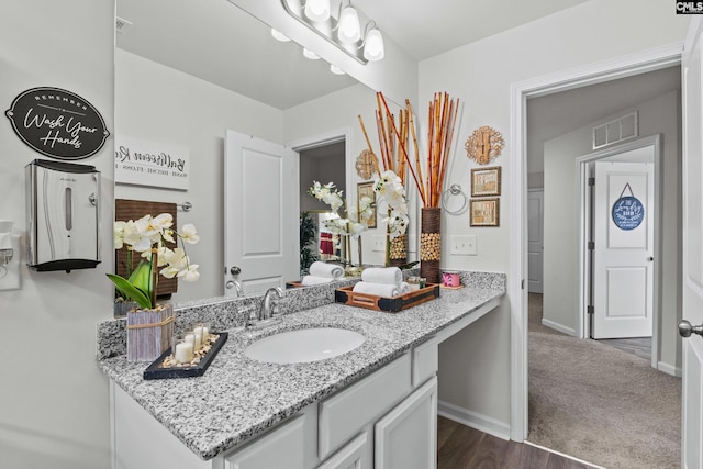 bathroom with vanity, baseboards, and visible vents