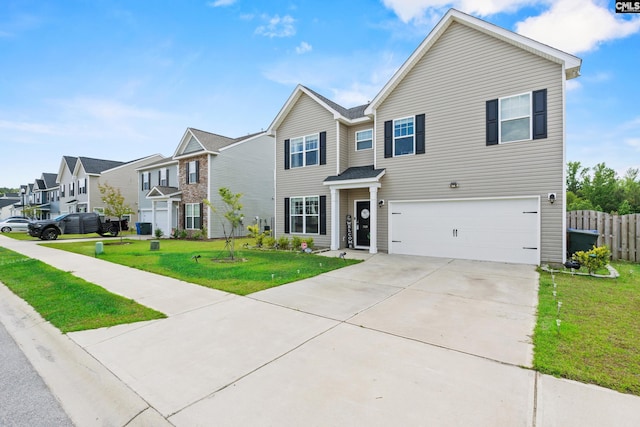view of front of property featuring a front yard, a residential view, a garage, fence, and concrete driveway