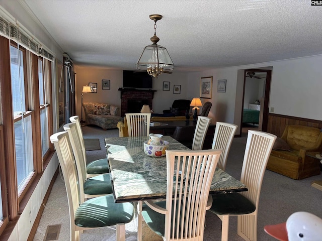 829 Rocky Point Cir, Ridgeway, SC 29130 - carpeted dining room featuring wainscoting, a brick fireplace, a textured ceiling, and visible vents