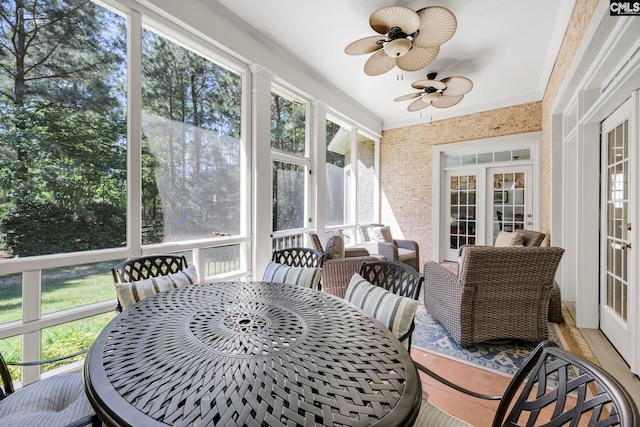 sunroom featuring ceiling fan, french doors, and outdoor dining area