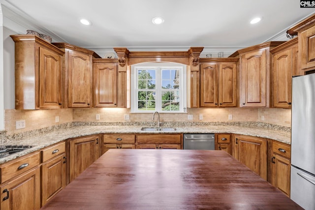 kitchen featuring ornamental molding, butcher block countertops, tasteful backsplash, a sink, and stainless steel appliances