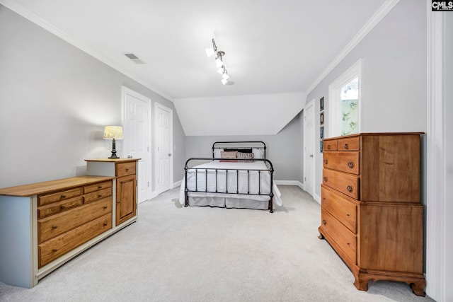 bedroom featuring visible vents, vaulted ceiling, baseboards, ornamental molding, and light carpet