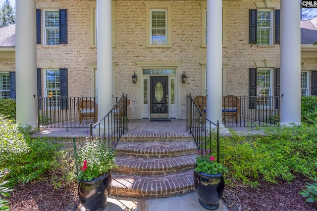 doorway to property with brick siding