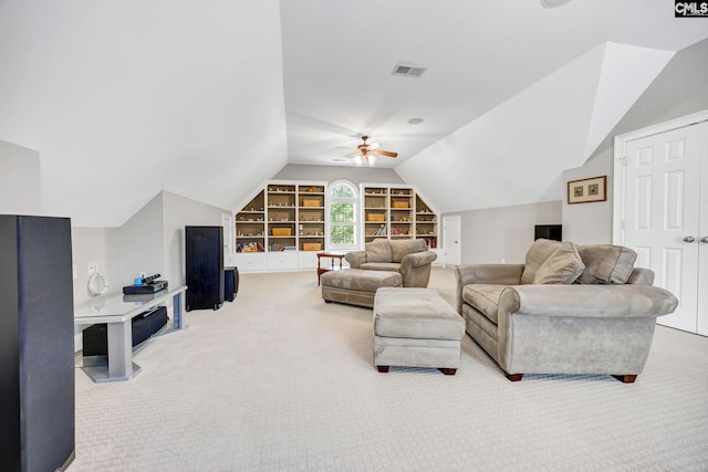 living area featuring carpet, a ceiling fan, built in shelves, and lofted ceiling