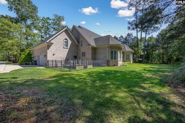 view of side of home featuring driveway, a lawn, a garage, brick siding, and fence