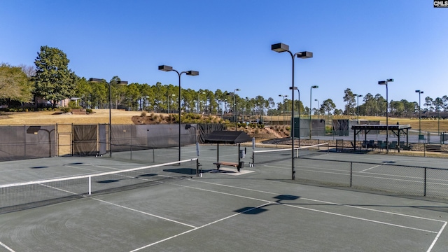 view of tennis court featuring fence