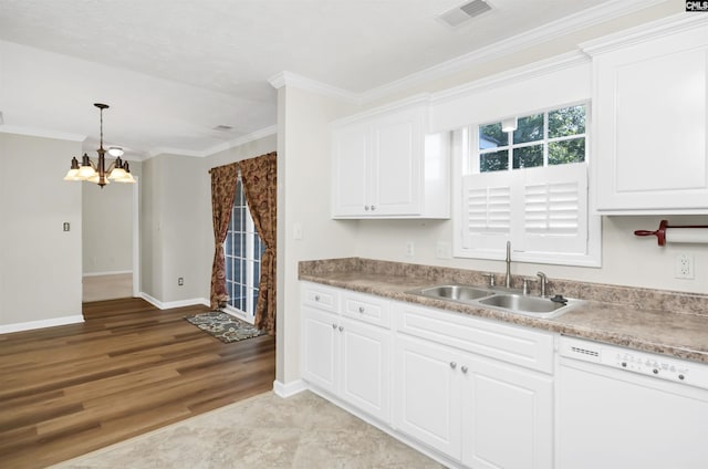 kitchen featuring white dishwasher, a sink, white cabinets, a chandelier, and ornamental molding