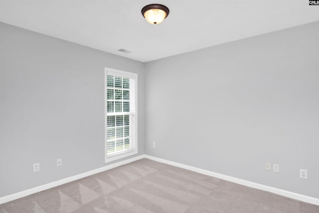 empty room with baseboards, carpet, and visible vents