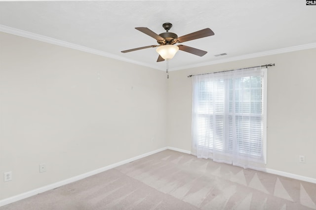 empty room with a ceiling fan, visible vents, baseboards, ornamental molding, and light carpet