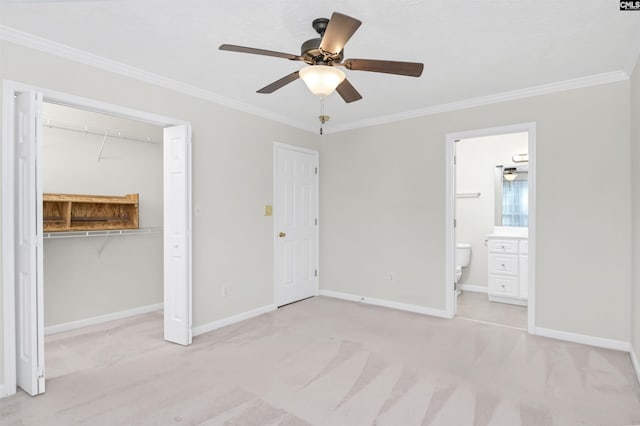 unfurnished bedroom with baseboards, light colored carpet, ornamental molding, and a closet