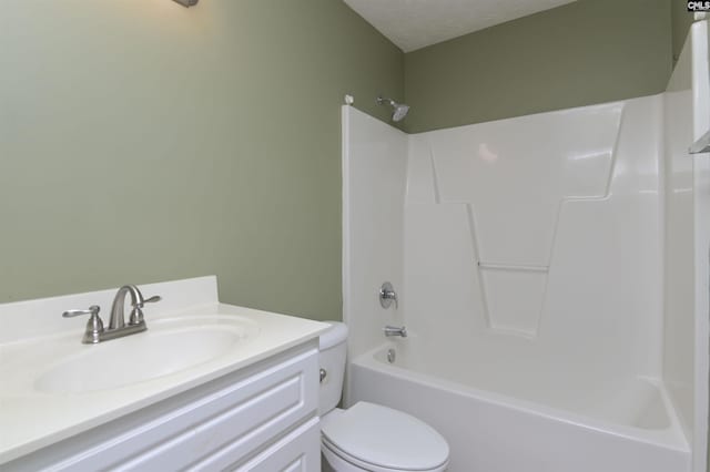full bathroom featuring vanity, a textured ceiling, shower / bathing tub combination, and toilet