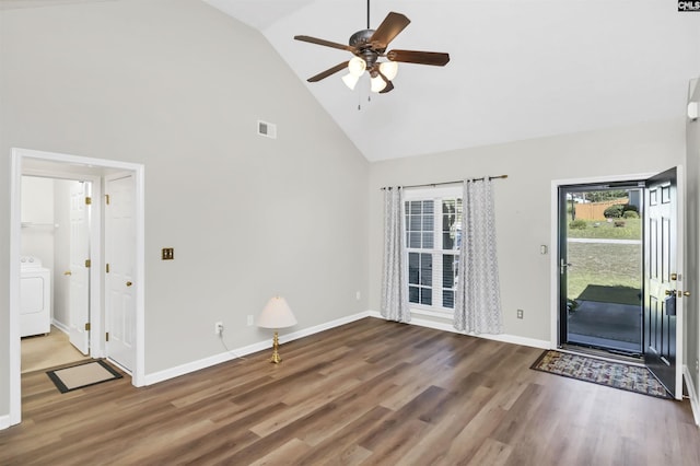 interior space with visible vents, washer / dryer, wood finished floors, high vaulted ceiling, and a ceiling fan