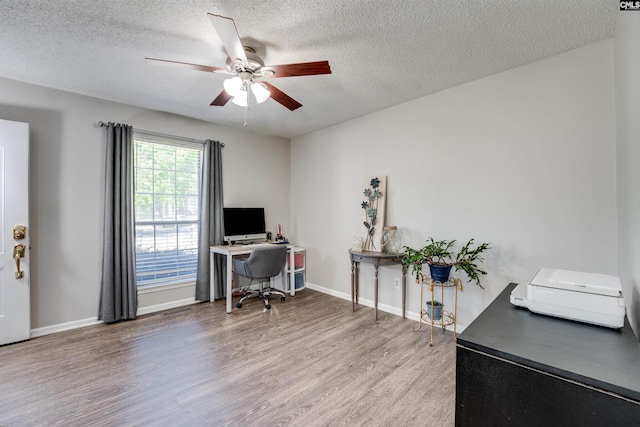 office with ceiling fan, a textured ceiling, visible vents, wood finished floors, and baseboards