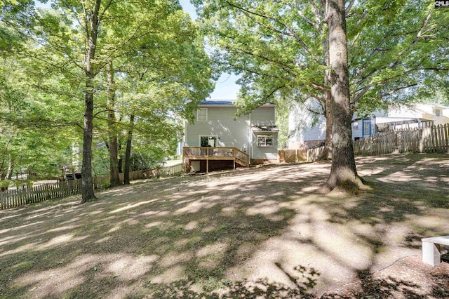 view of yard featuring a fenced backyard and a wooden deck