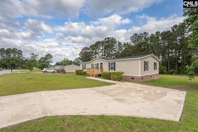 manufactured / mobile home with a front yard, crawl space, and a deck