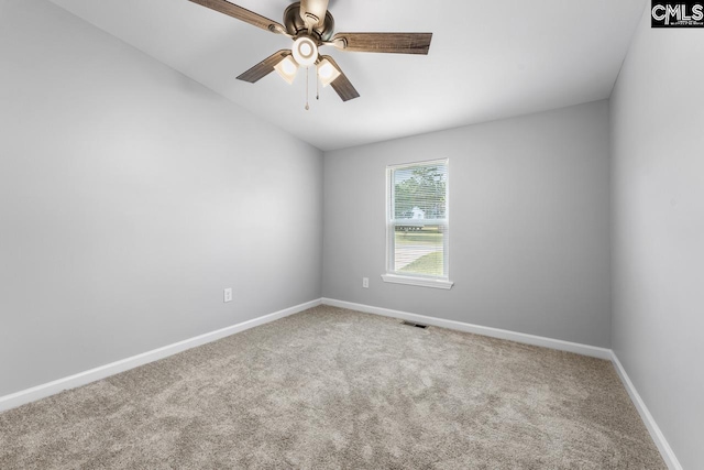 spare room featuring a ceiling fan, baseboards, visible vents, and carpet