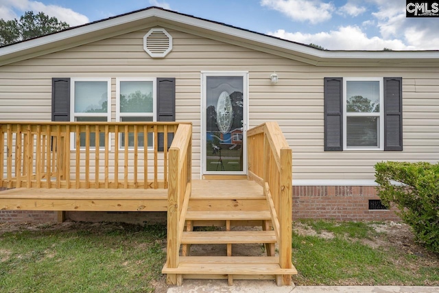 rear view of house with crawl space and a wooden deck