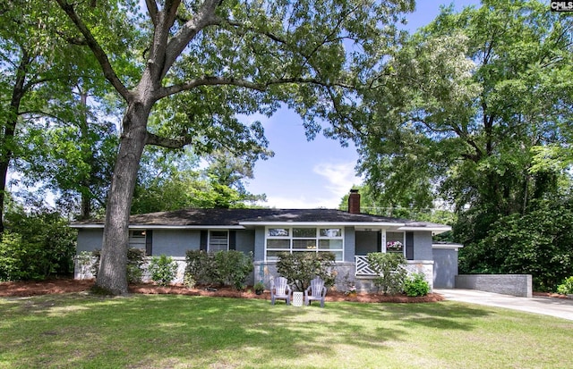 single story home with a chimney and a front lawn