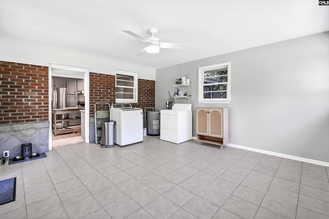 interior space featuring light tile patterned floors, water heater, a ceiling fan, and brick wall