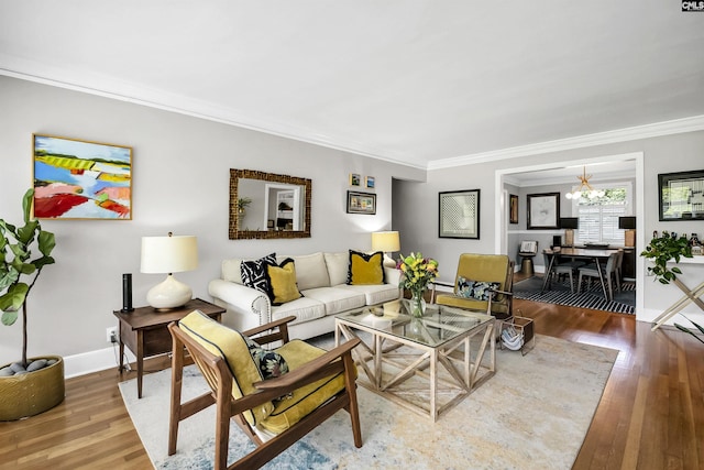living room featuring crown molding, baseboards, and wood finished floors
