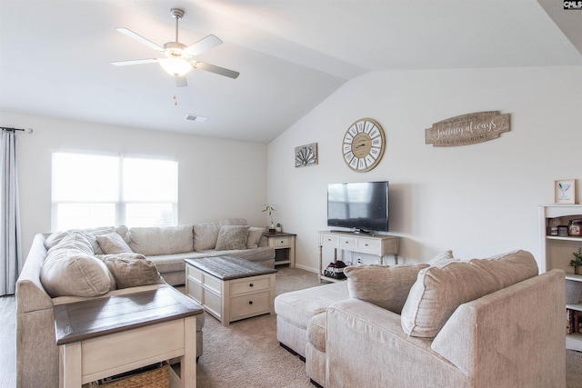 living area featuring visible vents, ceiling fan, lofted ceiling, and light carpet
