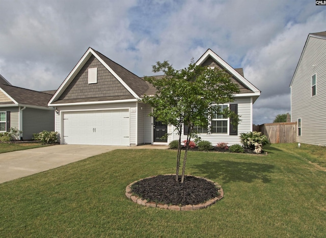 view of front of home featuring fence, an attached garage, driveway, and a front yard
