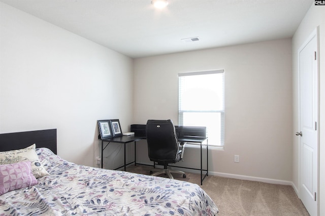 carpeted bedroom featuring baseboards, visible vents, and multiple windows