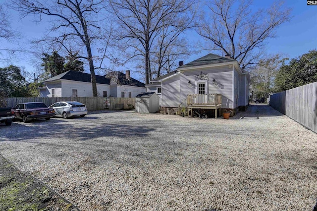 view of yard featuring fence and a wooden deck