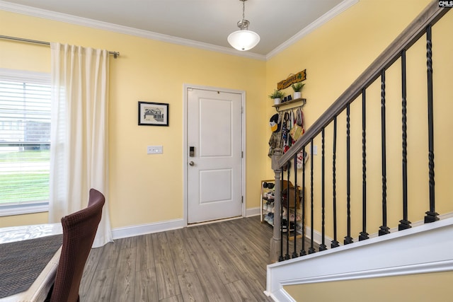 entryway with baseboards, ornamental molding, stairs, and wood finished floors