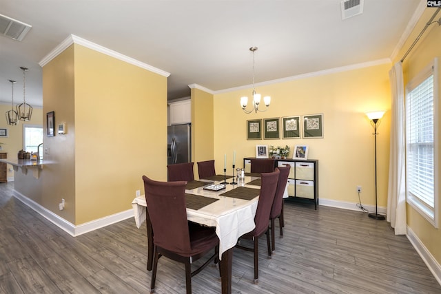 dining space with visible vents, dark wood finished floors, and a notable chandelier