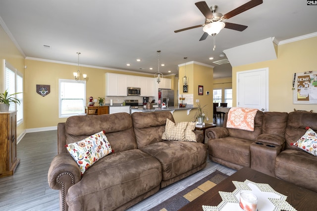 living room with crown molding, recessed lighting, baseboards, and ceiling fan