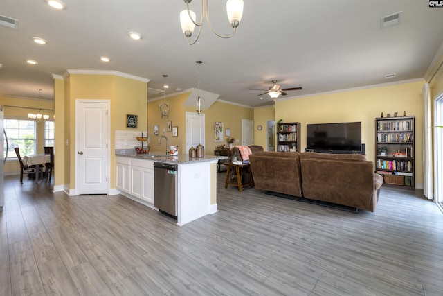 kitchen with visible vents, crown molding, a sink, ceiling fan with notable chandelier, and dishwasher