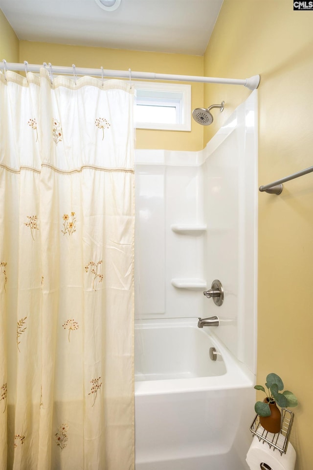 bathroom with shower / tub combo with curtain