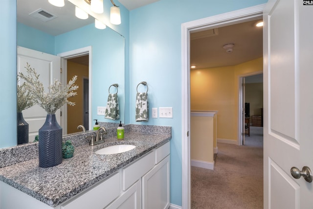 bathroom with visible vents, baseboards, and vanity