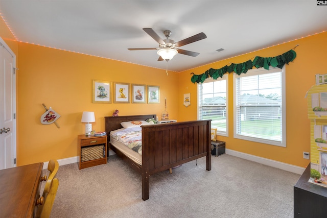 bedroom featuring light colored carpet, baseboards, ceiling fan, and visible vents