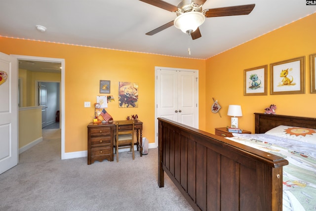 bedroom with baseboards, a closet, light carpet, and ceiling fan