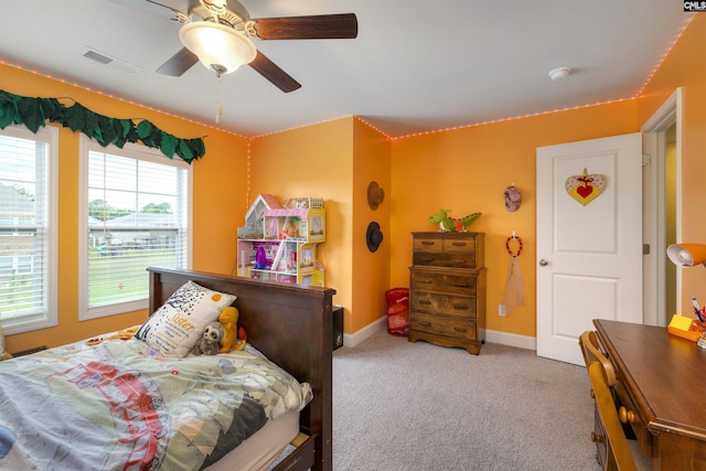 carpeted bedroom featuring baseboards, visible vents, and ceiling fan