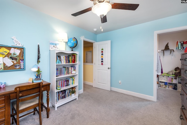 office area with carpet floors, baseboards, and a ceiling fan
