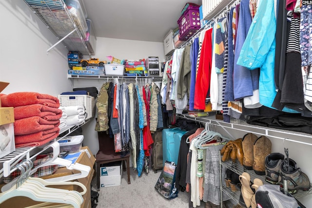 walk in closet with carpet